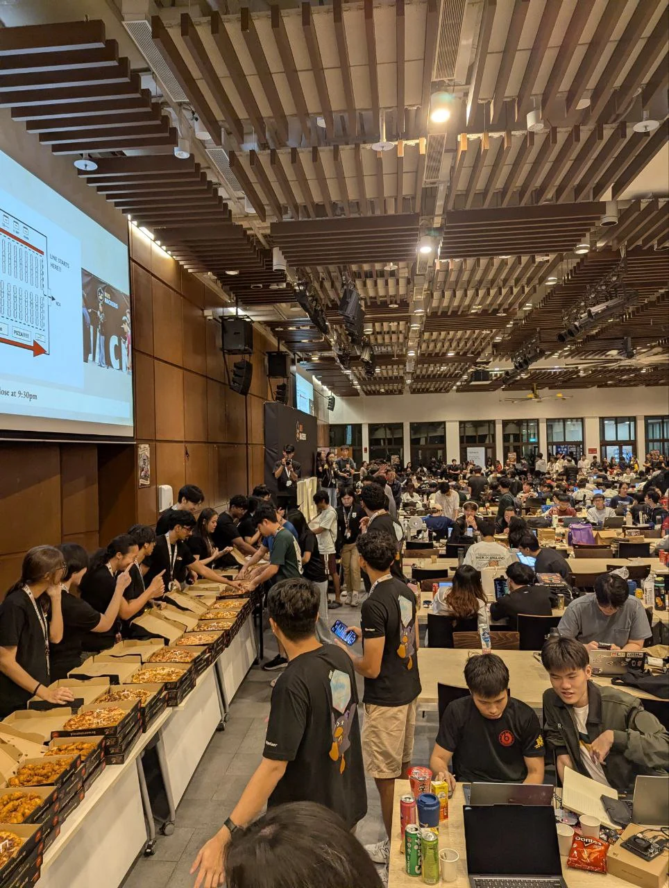 Hack&Roll participants and volunteers at the food line in the main hall